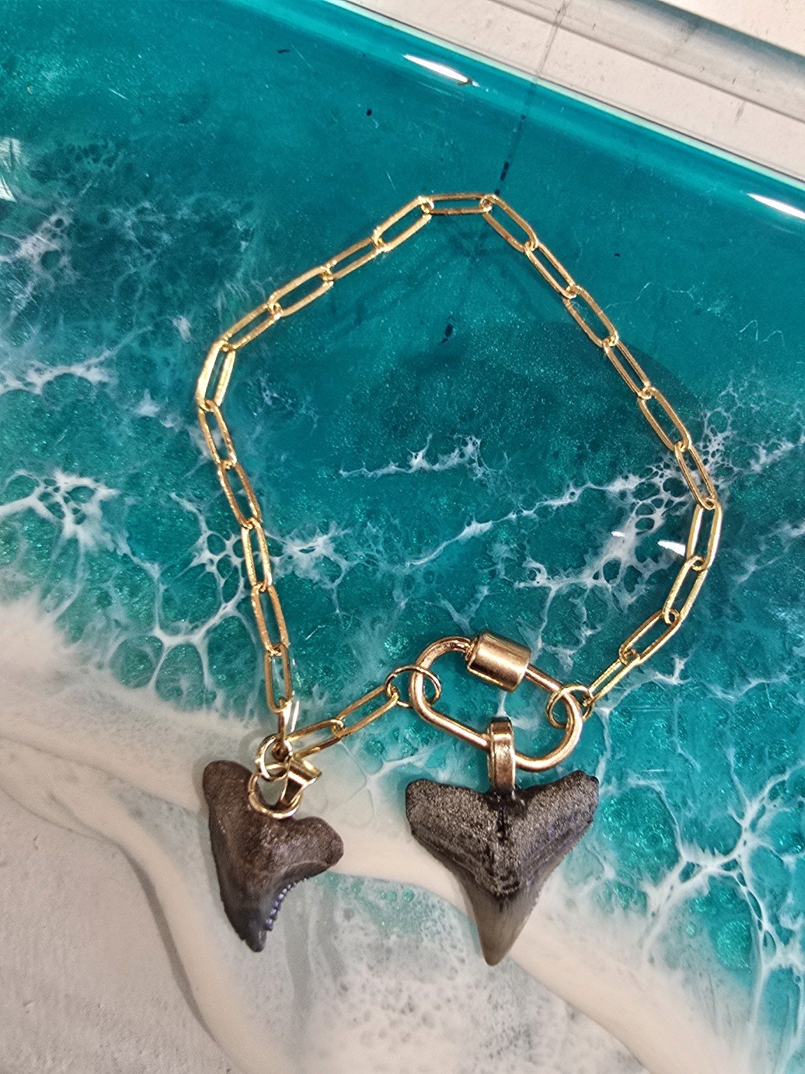 Shark tooth bracelet on ocean art